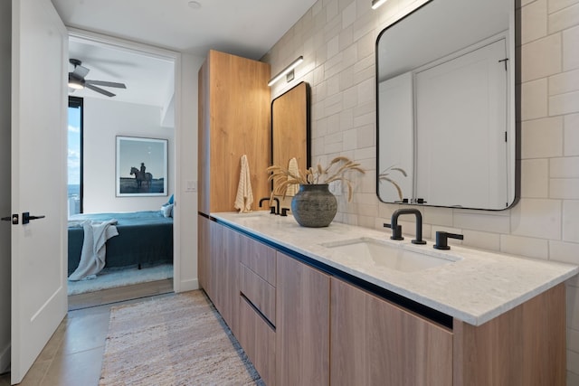 bathroom with vanity, tasteful backsplash, tile patterned floors, and ceiling fan