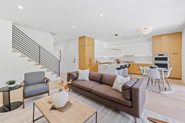 4505 Shoal Creek St, Austin, TX 78756 - living room featuring recessed lighting, light wood-type flooring, and stairway