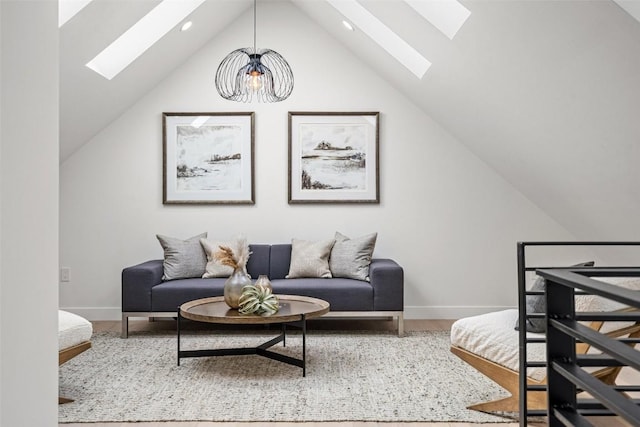 living room with vaulted ceiling with skylight and a chandelier