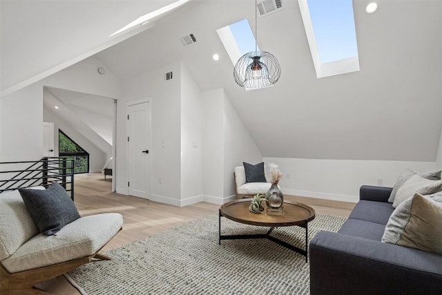 living room with light hardwood / wood-style flooring and vaulted ceiling