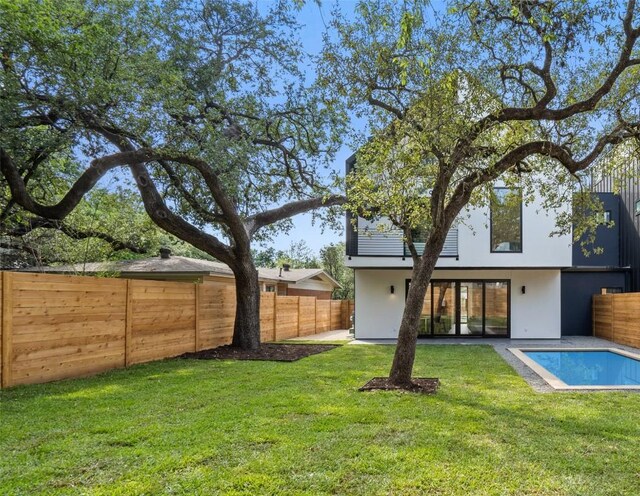 4505 Shoal Creek St, Austin, TX 78756 - rear view of house with stucco siding and a fenced backyard