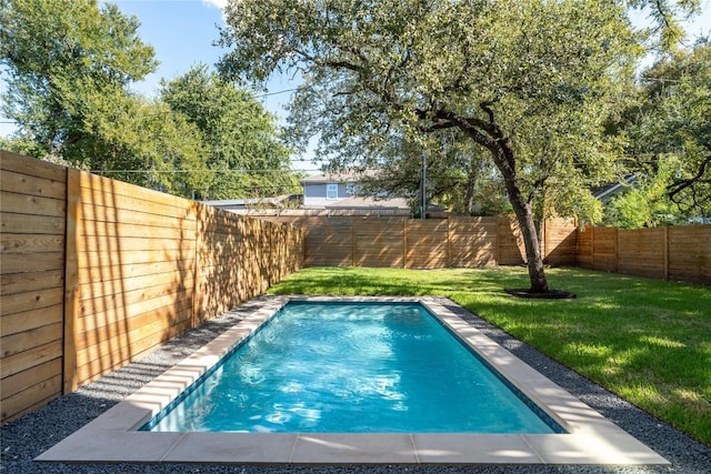 view of pool featuring a lawn