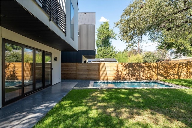 view of yard featuring a fenced in pool and a patio