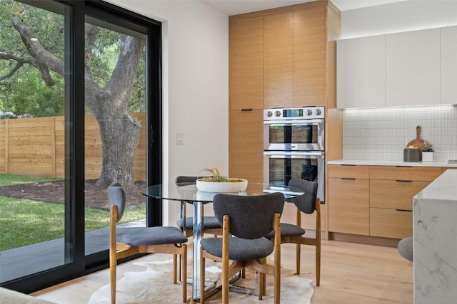 dining space with light hardwood / wood-style floors