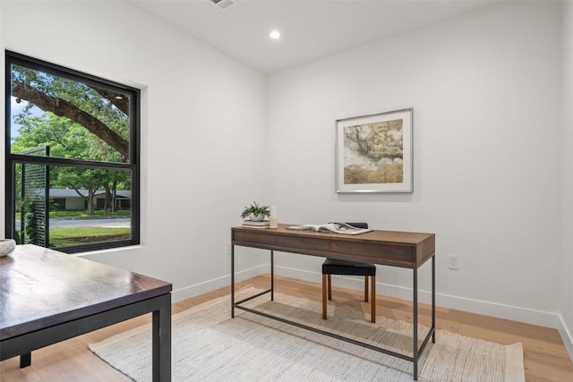 office with light wood-type flooring