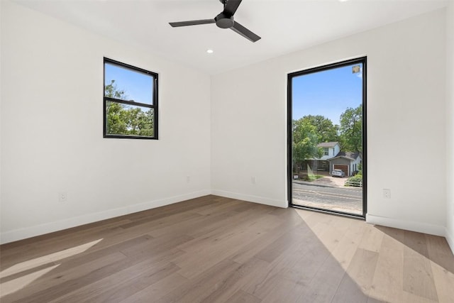 spare room featuring ceiling fan and light hardwood / wood-style floors