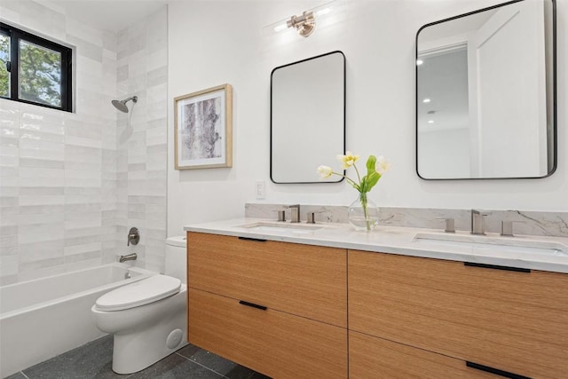 full bathroom featuring tile patterned flooring, toilet, vanity, and tiled shower / bath