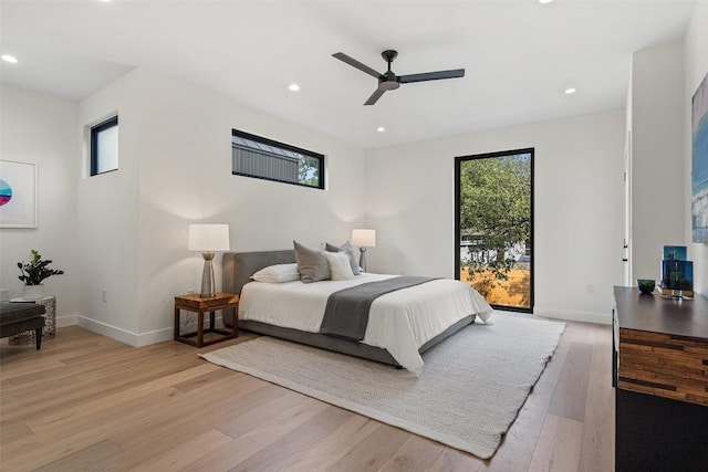 bedroom featuring access to exterior, light hardwood / wood-style flooring, and ceiling fan