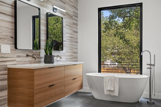 bathroom featuring vanity, tile patterned floors, and a bathtub