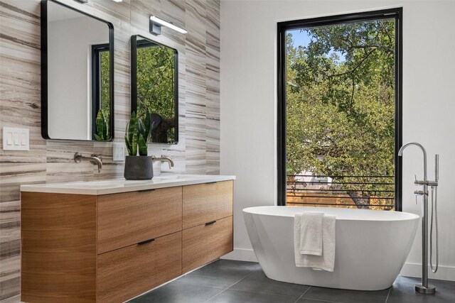 4505 Shoal Creek St, Austin, TX 78756 - bathroom with double vanity, a freestanding bath, and tile patterned flooring