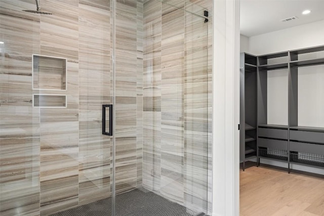 bathroom featuring hardwood / wood-style floors and walk in shower