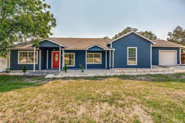 single story home featuring a garage and a front lawn