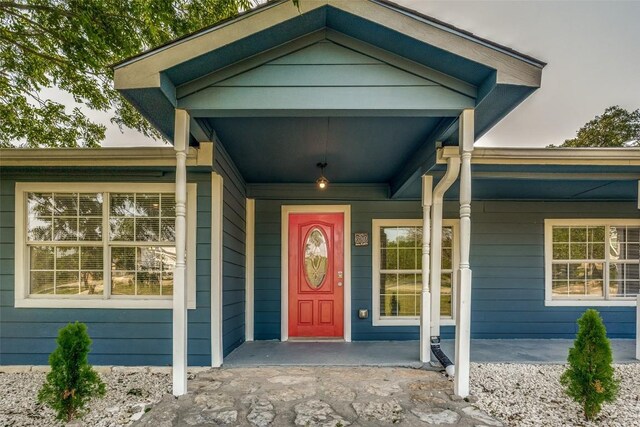 doorway to property featuring covered porch