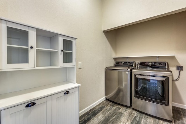 laundry area featuring laundry area, wood tiled floor, baseboards, and separate washer and dryer