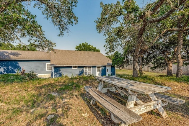 rear view of property with fence