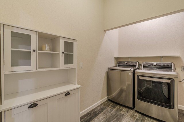 560 Persimmon Pass, Fischer, TX 78623 - laundry area featuring dark wood-style floors, washing machine and dryer, and baseboards