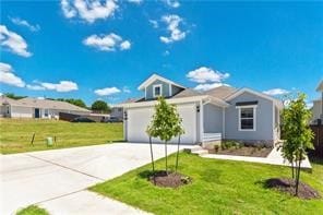 view of front of home featuring a front yard and a garage