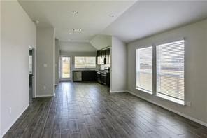 unfurnished living room with dark hardwood / wood-style floors