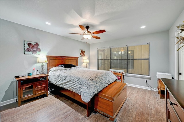 bedroom with hardwood / wood-style flooring and ceiling fan