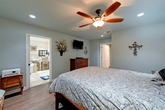 bedroom featuring ensuite bath, ceiling fan, and light hardwood / wood-style floors