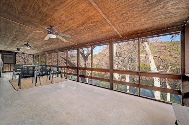 unfurnished sunroom featuring ceiling fan