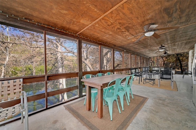 unfurnished sunroom featuring ceiling fan and wood ceiling