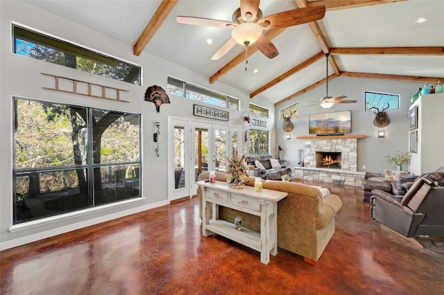 187 N Roy Chisum Rd, Leakey, TX 78873 - living room featuring ceiling fan, concrete floors, beam ceiling, high vaulted ceiling, and a stone fireplace