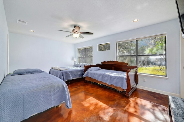 bedroom with ceiling fan and multiple windows