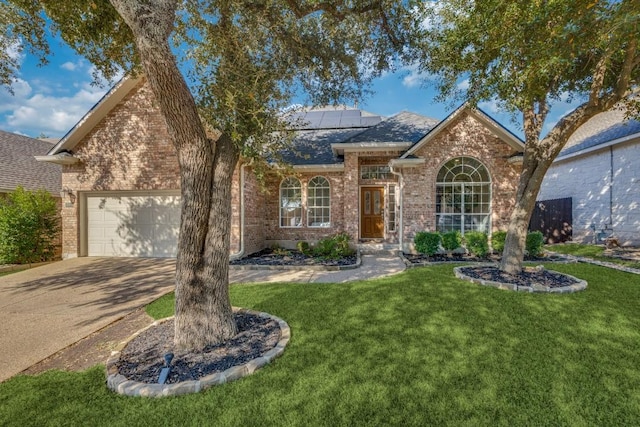 view of front of property featuring solar panels, a garage, and a front lawn