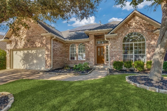 view of front of home featuring a front lawn, a garage, and solar panels