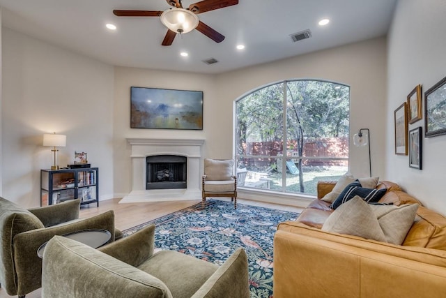 living room with a wealth of natural light and ceiling fan