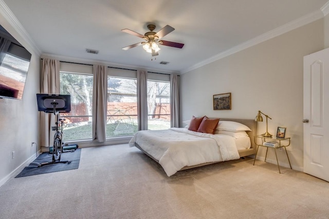 bedroom with ceiling fan, light carpet, and ornamental molding