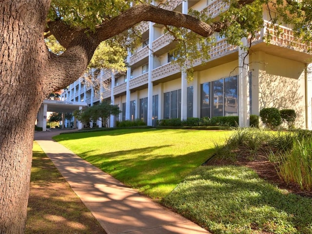 view of property's community with a lawn