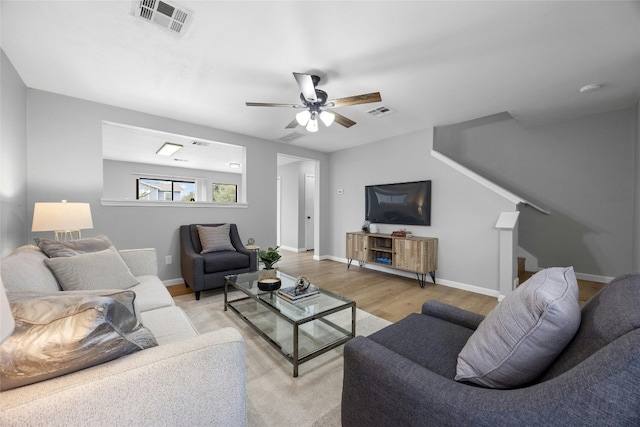 living room with ceiling fan and light hardwood / wood-style floors