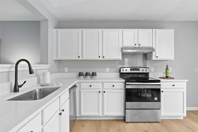 kitchen featuring sink, white cabinets, light hardwood / wood-style floors, and appliances with stainless steel finishes