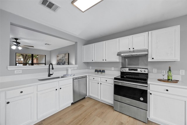 kitchen with white cabinets, sink, ceiling fan, appliances with stainless steel finishes, and light hardwood / wood-style floors