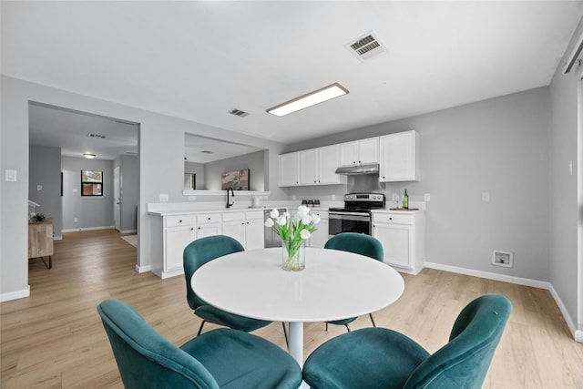 dining space with light hardwood / wood-style floors