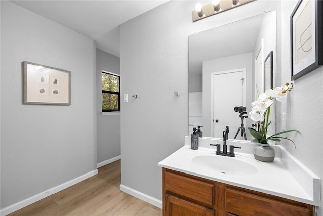 bathroom with hardwood / wood-style floors and vanity