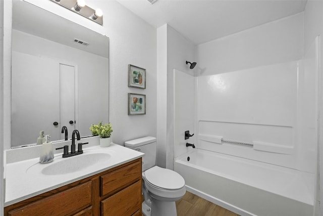 full bathroom featuring shower / tub combination, vanity, toilet, and wood-type flooring