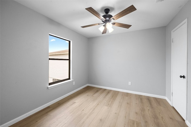 empty room with ceiling fan and light hardwood / wood-style flooring