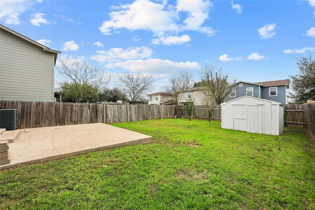 view of yard with central AC unit, a patio, and a shed