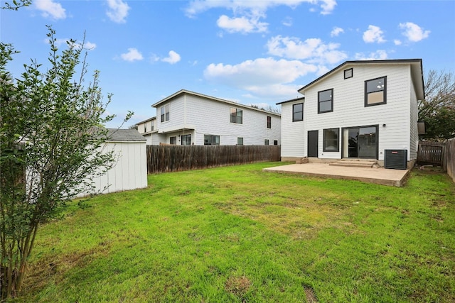 back of property with a lawn, cooling unit, a patio, and a storage shed