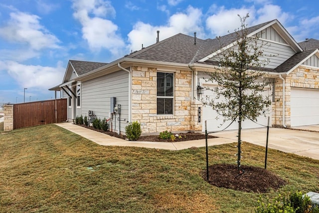 view of front of property featuring a garage and a front lawn