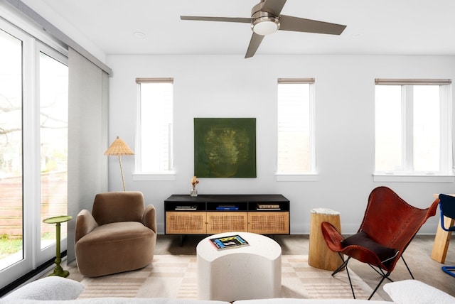 living room with ceiling fan and light colored carpet