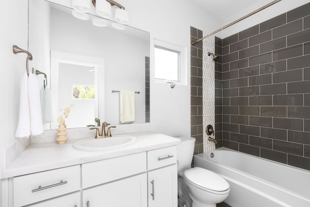 full bathroom featuring vanity, toilet, and tiled shower / bath