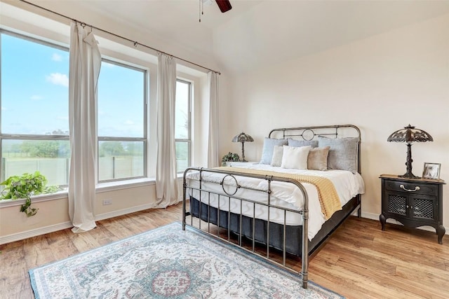 bedroom featuring ceiling fan, lofted ceiling, and light hardwood / wood-style floors