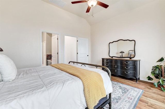 bedroom featuring ceiling fan, lofted ceiling, and light wood-type flooring