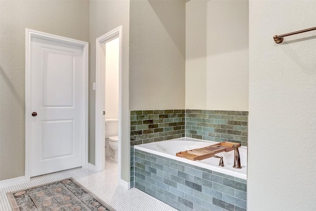 bathroom with tile patterned flooring, tiled bath, and toilet