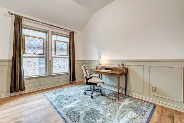 office featuring light wood-type flooring, vaulted ceiling, and plenty of natural light