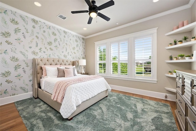 bedroom featuring dark wood-type flooring, ceiling fan, and ornamental molding